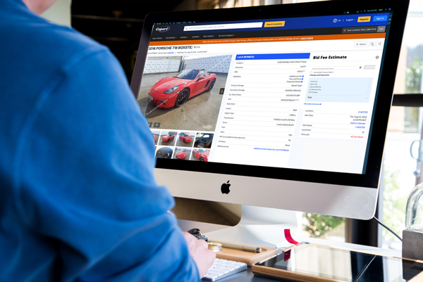 someone using the bid fee calculator on the copart website on a desktop computer