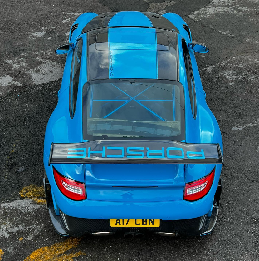 Blue Porsche from behind.