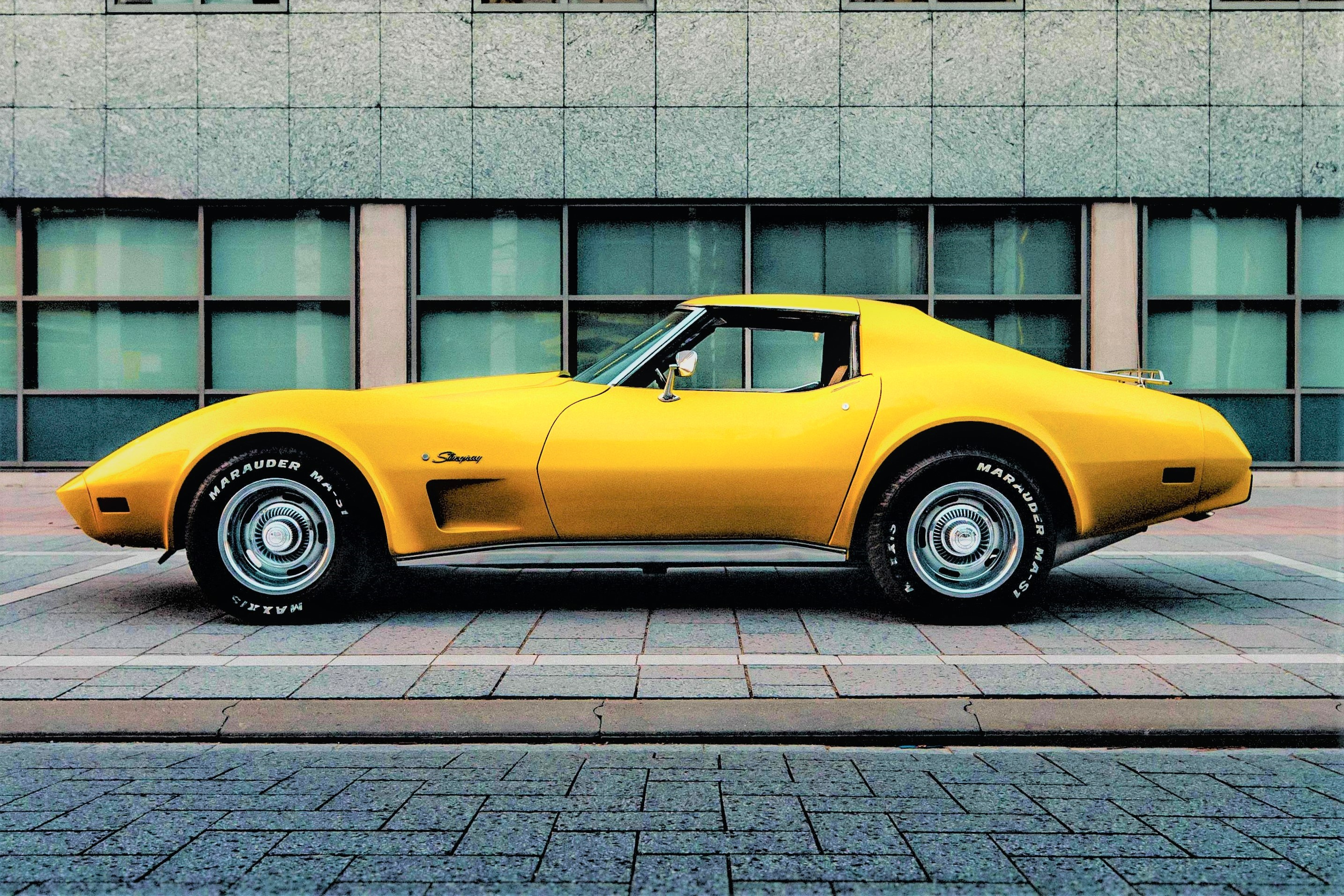 A yellow corvette sting ray classic car