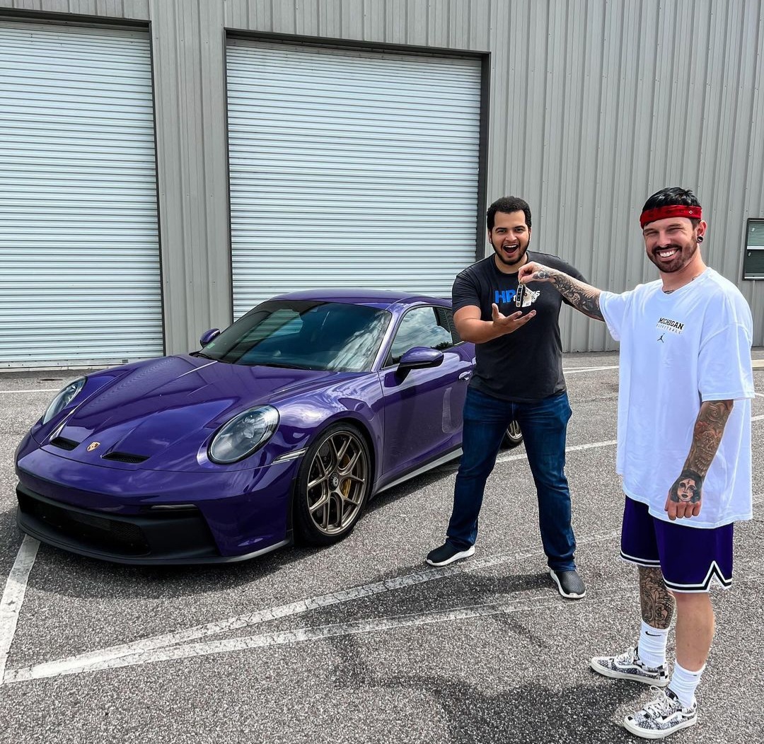 Mat and Tavarish standing next to the fixed purple Porsche 992 GT3