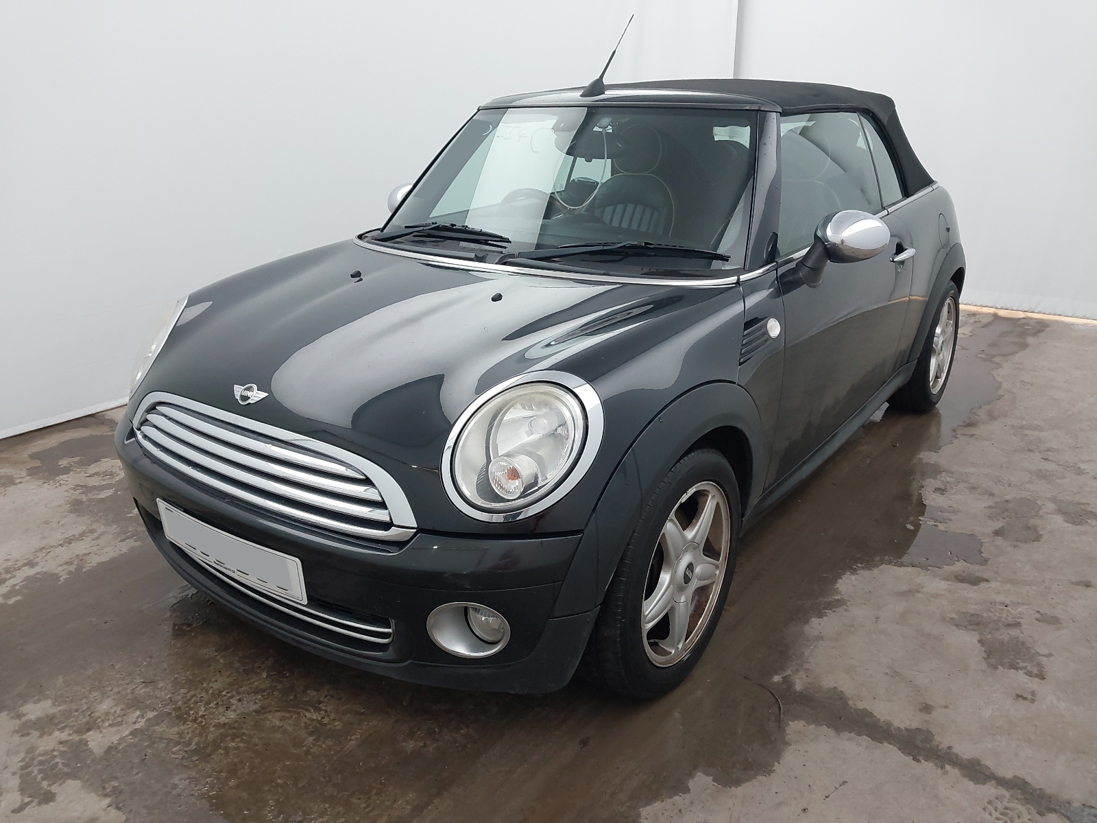A green Mini Cooper