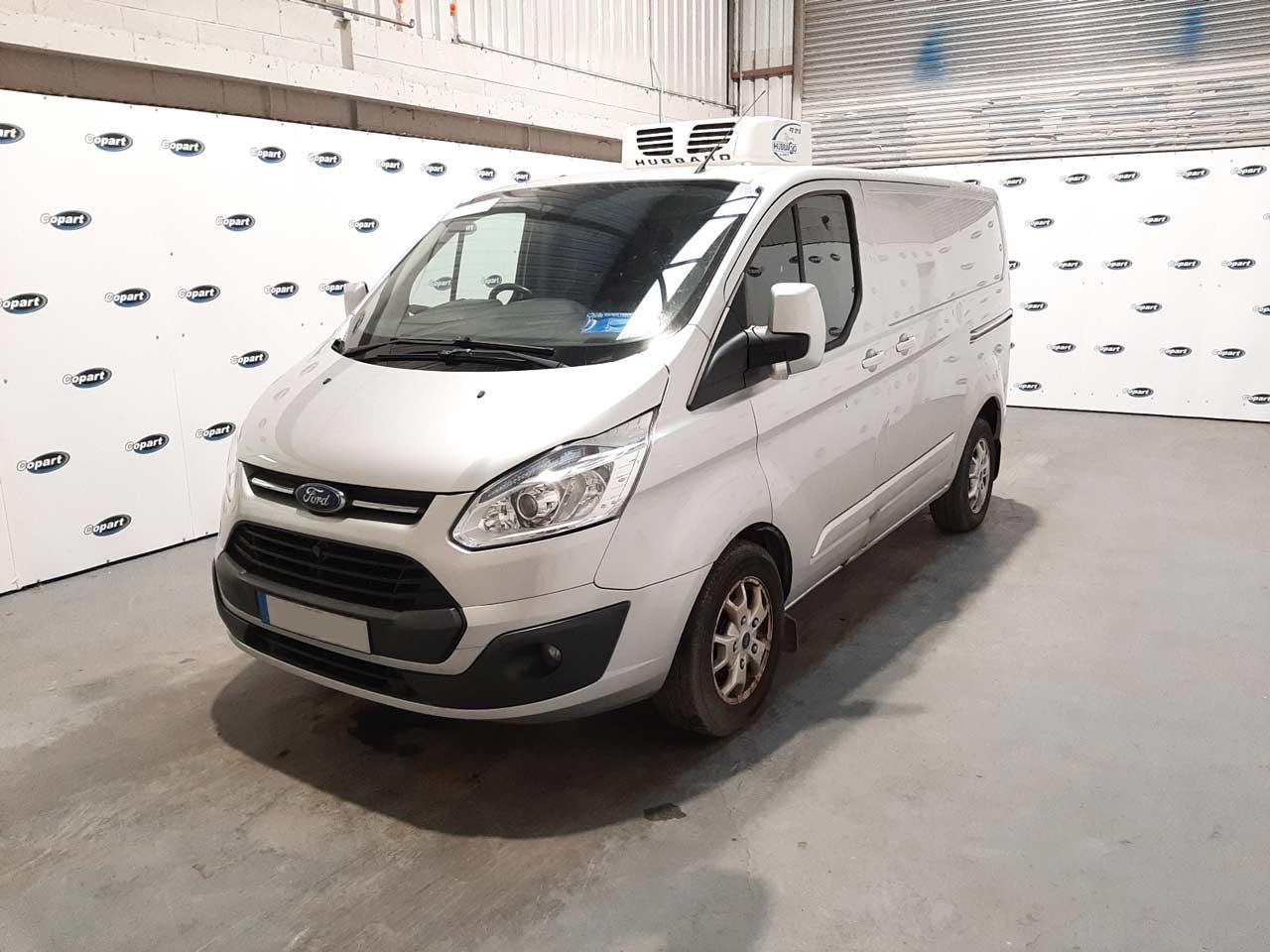 Silver Ford Transit Van parked in a Copart lot