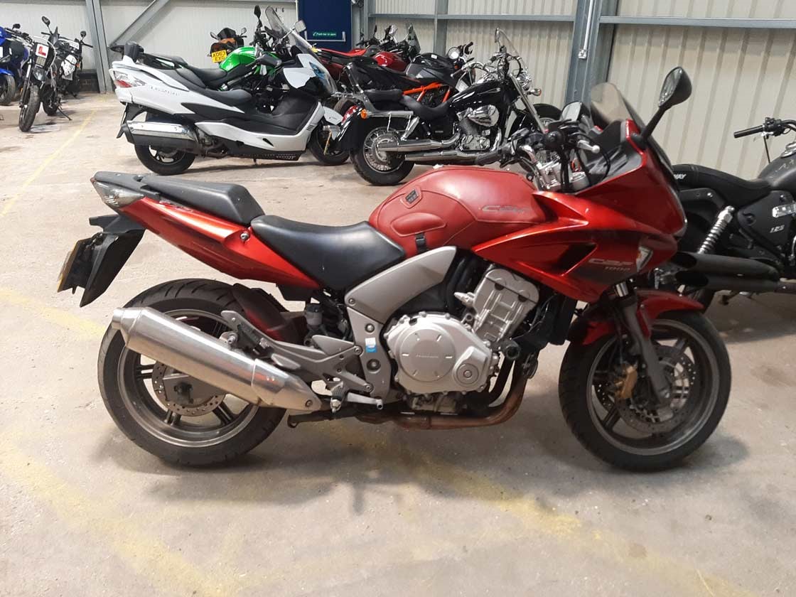 Parked red Honda CBF motorbike