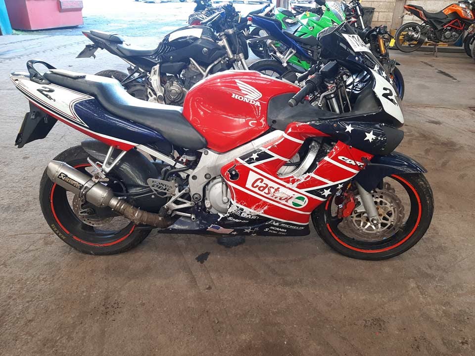 Red, white and blue Honda CBR motorbike
