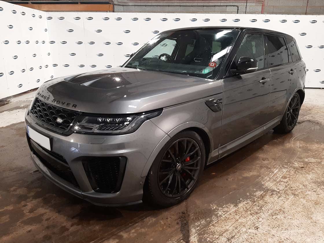 “A parked grey Land Rover Range Rover in a Copart lot.”