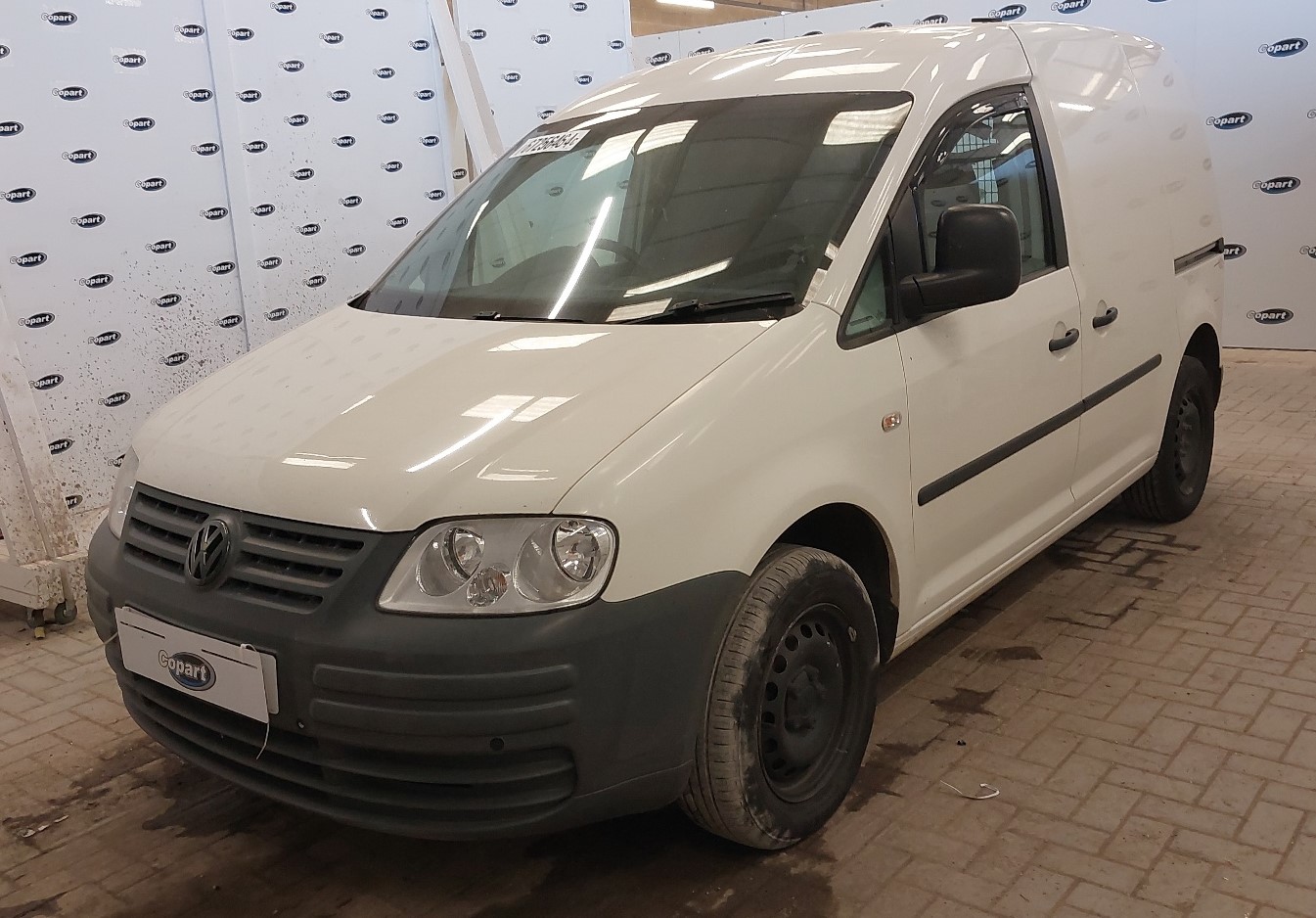 A white Volkswagen Caddy.